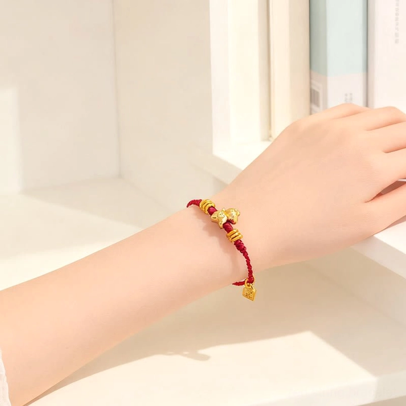 Minimalist red string horse lucky bracelet on windowsill