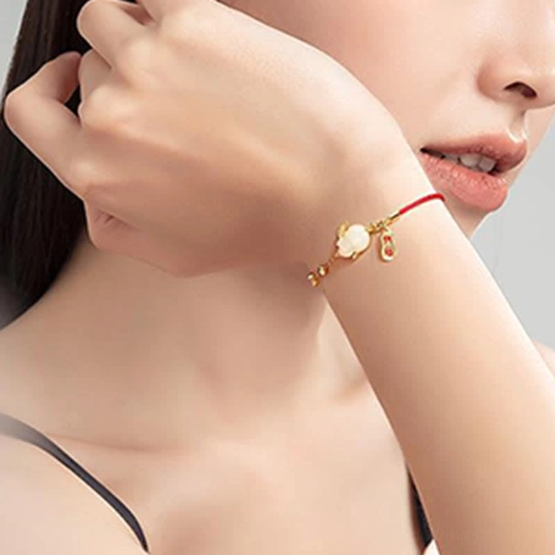 Minimalist white jade rabbit bracelet close up on model's hand