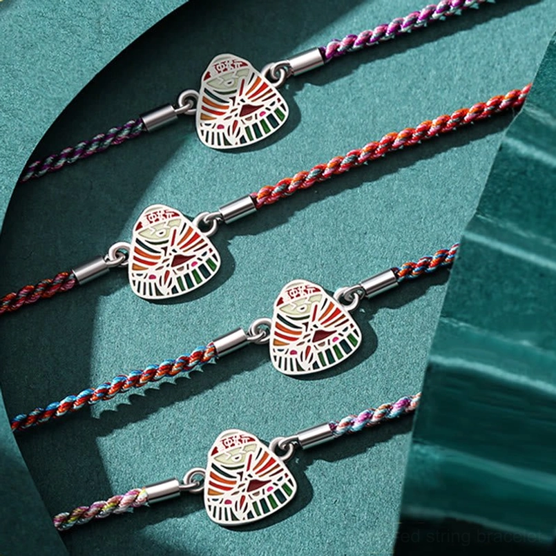 Multiple mixed color woven zongzi charm red string bracelets flat lay display