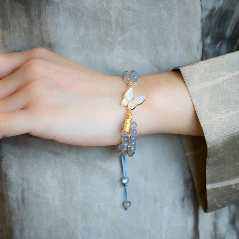 Blue Adjustable Red String Moonstone Bracelet Over Hand Flat Lay View