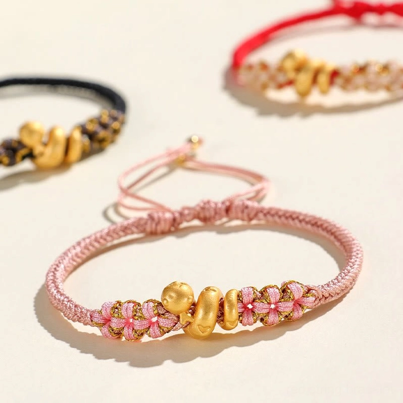 Flat lay view of multi color year of the snake peach blossom luck bracelets set