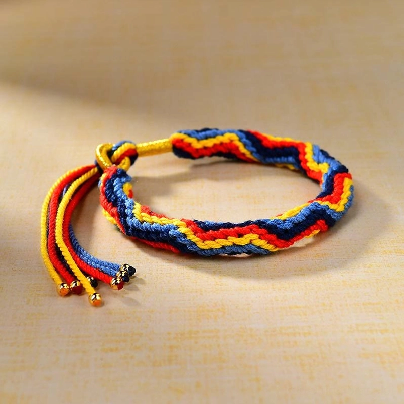 Hand woven Tibetan luck bracelet with adjustable tassel side view