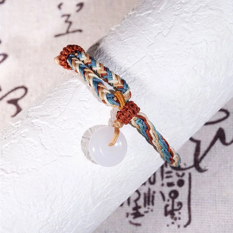 Close Up of Hetian Jade Peace Buckle Bracelet on Vintage Calligraphy Paper