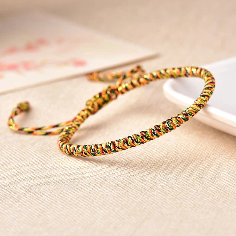 Multi-color braided red string bracelet with gold yellow green and red woven details