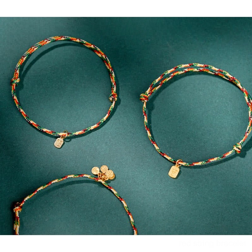 Multicolor lucky bracelet laid flat on natural linen surface