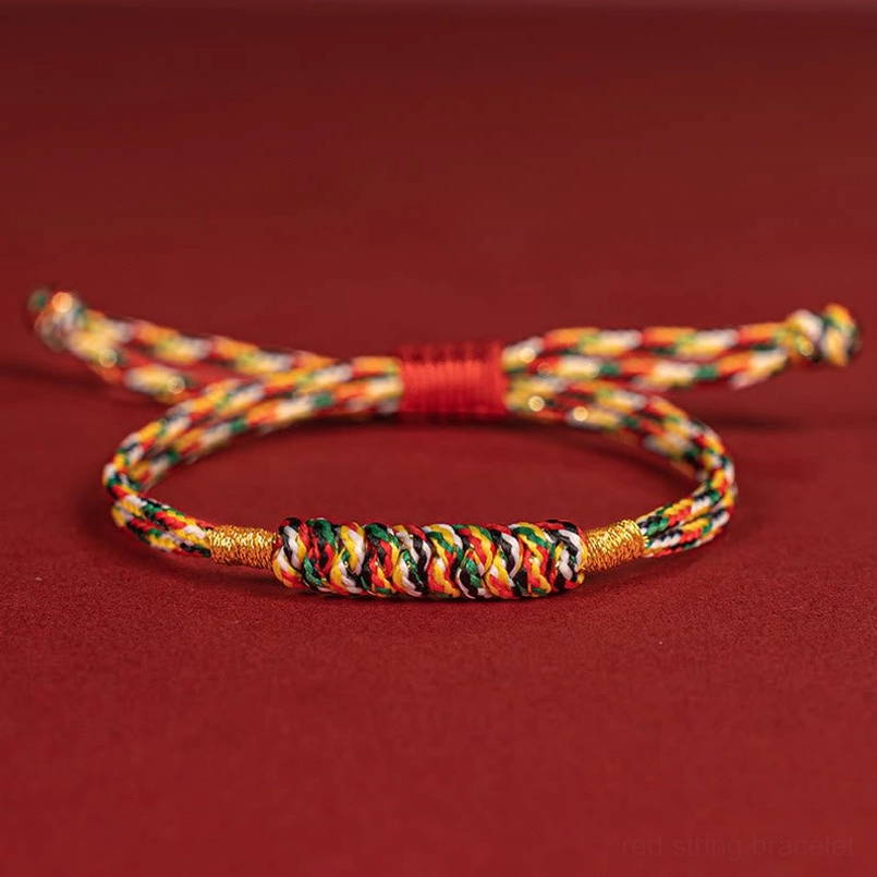 Vibrant multicolor red string lucky knot bracelet full view on red background