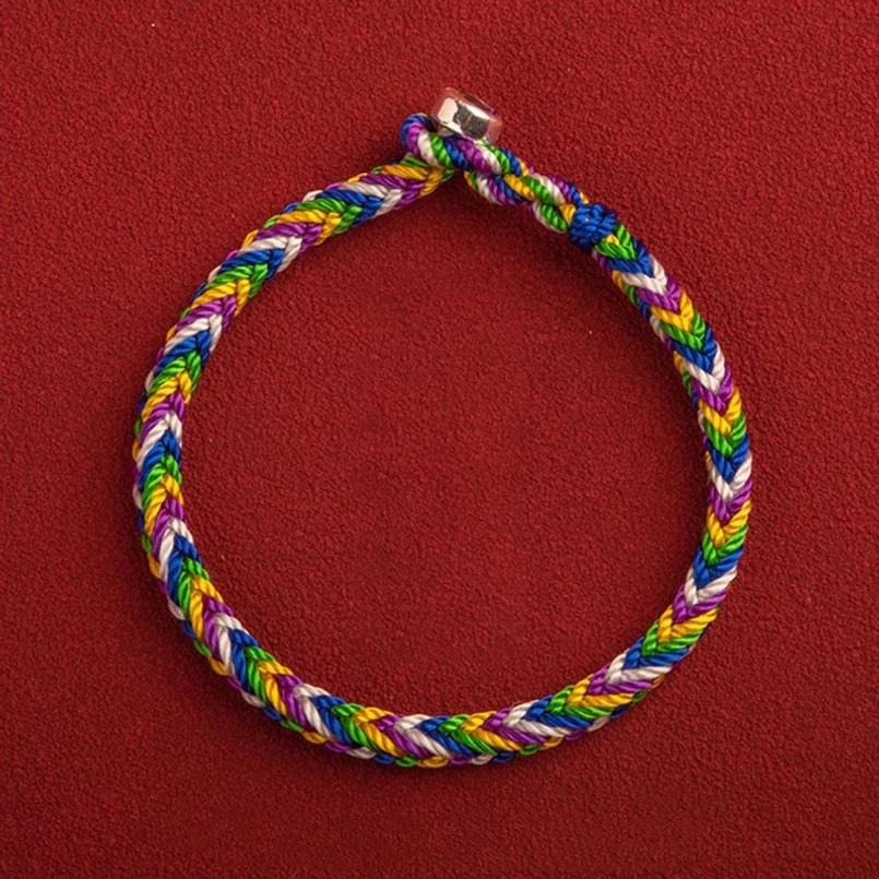 Multicolor lucky red string bracelet with vibrant woven threads and metal clasp, top-down view