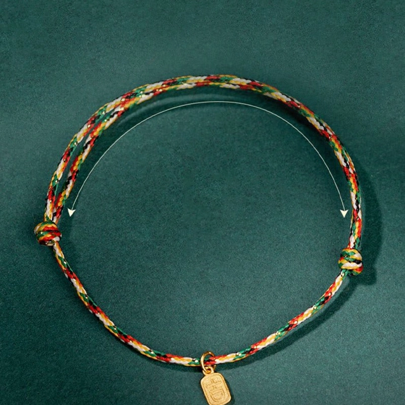 Multicolor red string bracelet showing adjustable length feature