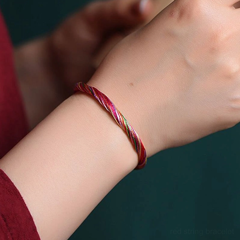 Multicolor red string protection bracelet side view on person's wrist