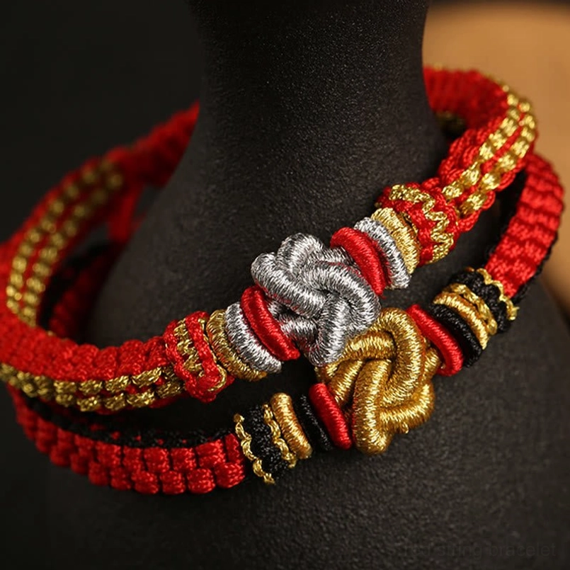 Colorful woven friendship bracelet with Chinese knot displayed on mannequin neck stand