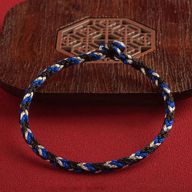 Dark tri-color weave multicolored bracelet with secure king kong knot on carved wood