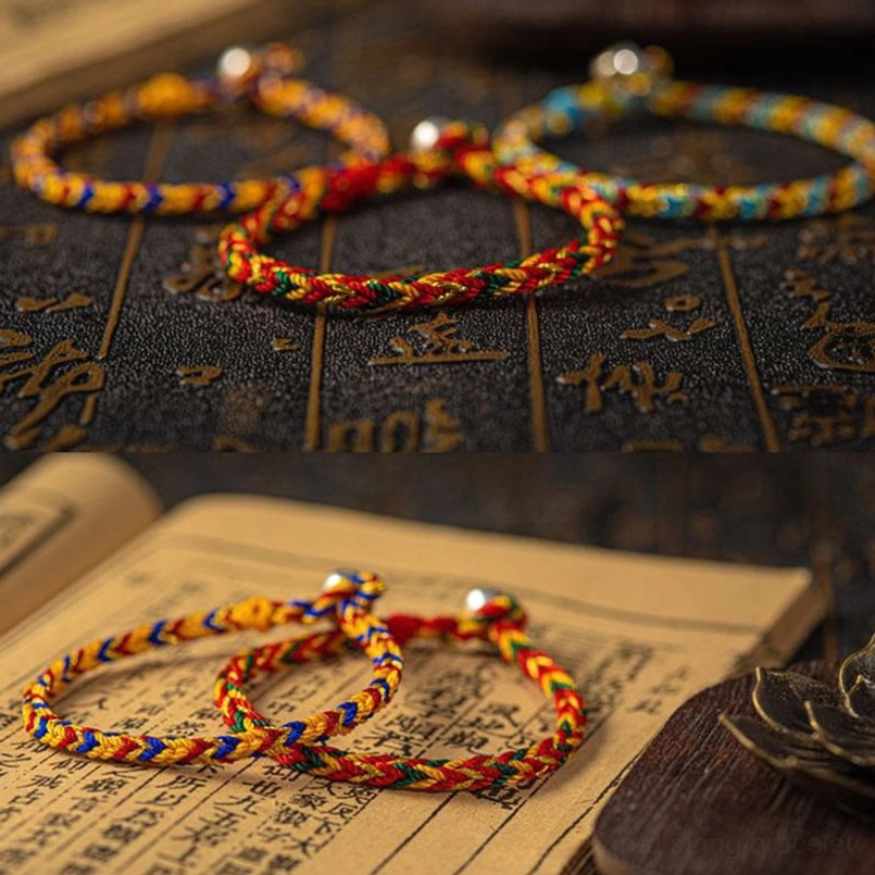 Three symmetrically arranged multicolored braided luck bracelets with metal fasteners