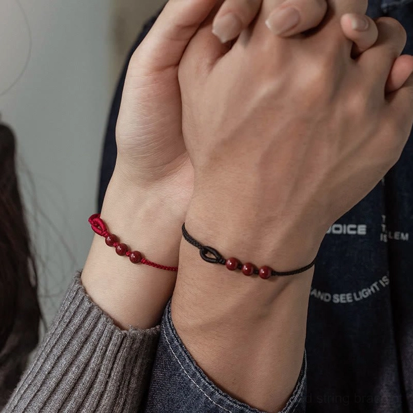 Multiple cinnabar bead red string bracelets collection display