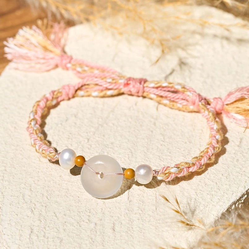 Peace Buckle Red String Bracelet on Linen Fabric with Dried Grass