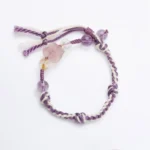 Fluorite amethyst red string bracelet flat lay on white background