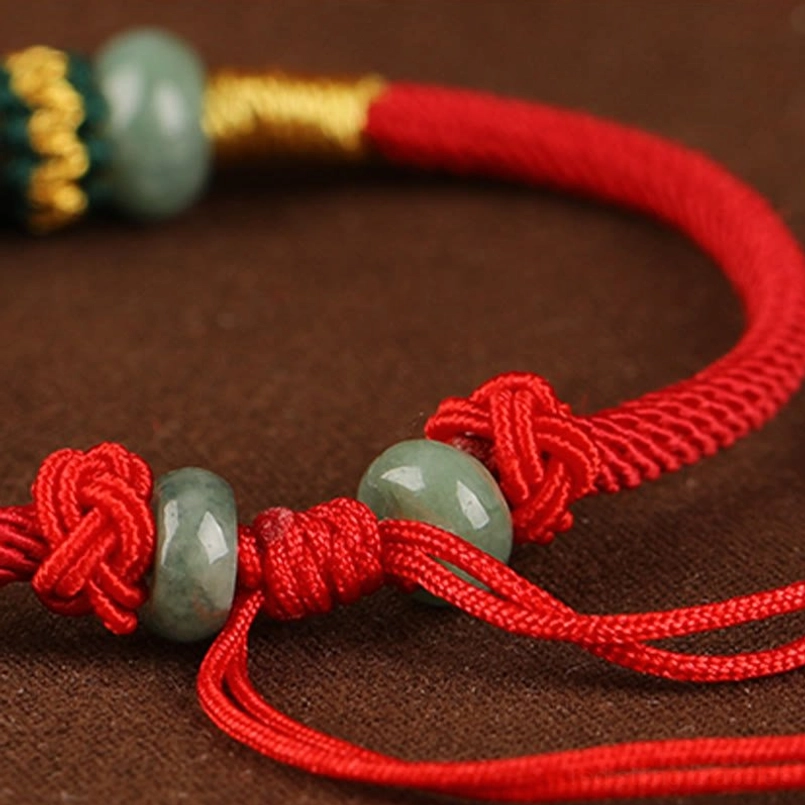 Natural jade abacus bead red string bracelet detail shot of gold woven accents
