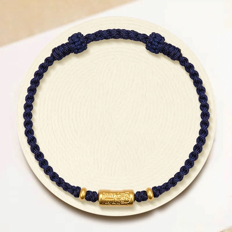 Dark blue lucky braided bracelet with carved 999 gold charm - decorative display