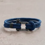 Navy blue titanium steel shackle rope bracelet with black metal buckle - front overhead view