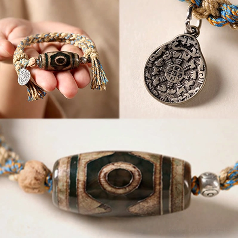 Ultra close up of engraved metal charm and Nine Eye Dzi Bead details