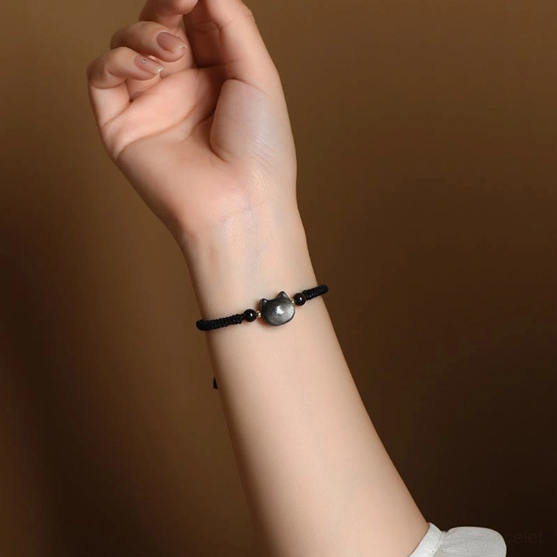 Slim minimalist Silver Sheen Obsidian cat bracelet worn on wrist, showing elegant everyday style