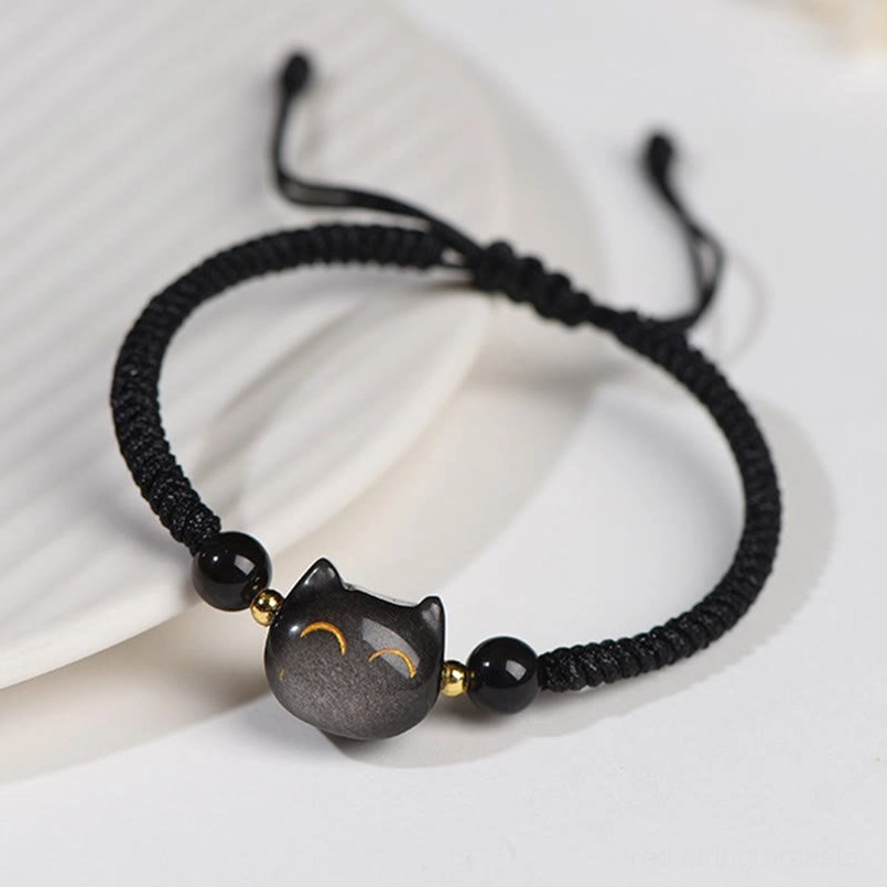 Close-up Silver Sheen Obsidian cat charm bracelet with gold spacer beads and adjustable pull cord detail