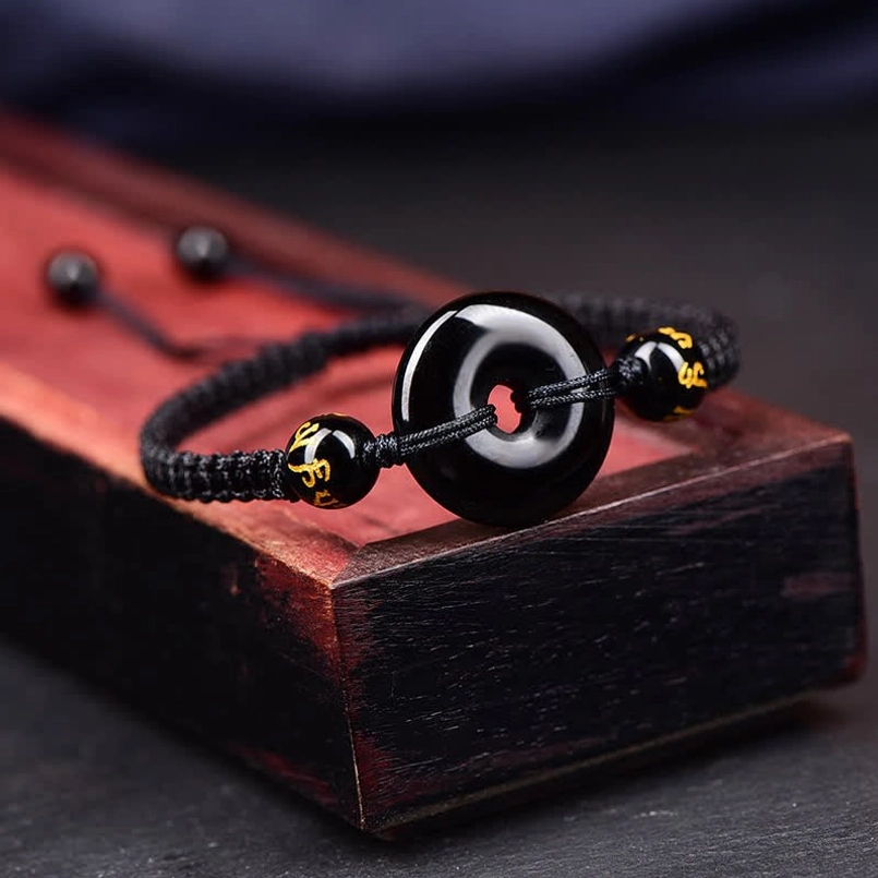 Black Obsidian Peace Buckle bracelet side angle showing engraved charm