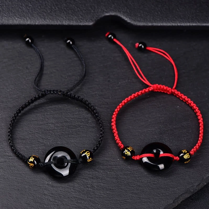 Comparison of two Black Obsidian Peace Buckle bracelets with red and black cords
