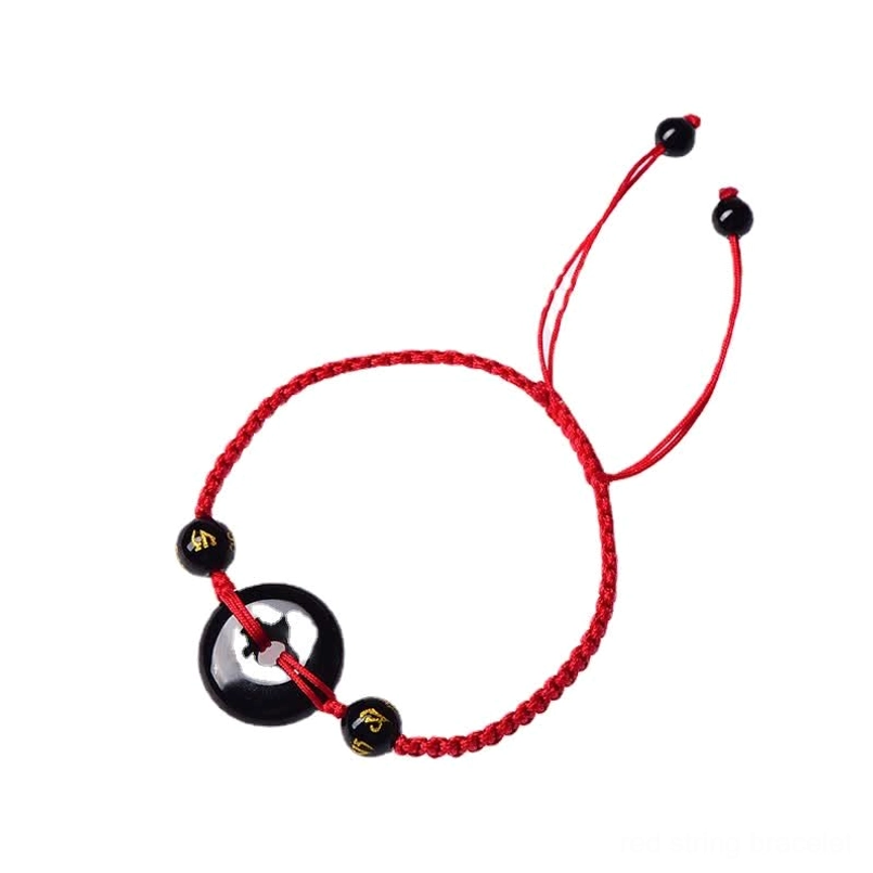 Black Obsidian Peace Buckle bracelet with red braided cord flat lay on dark background