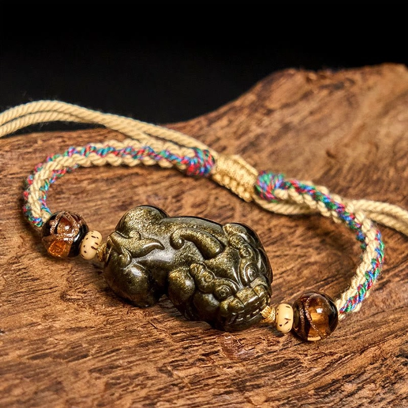 Side view of Gold Sheen Obsidian PiXiu charm showing lustrous golden sheen on black obsidian with stone spacer beads