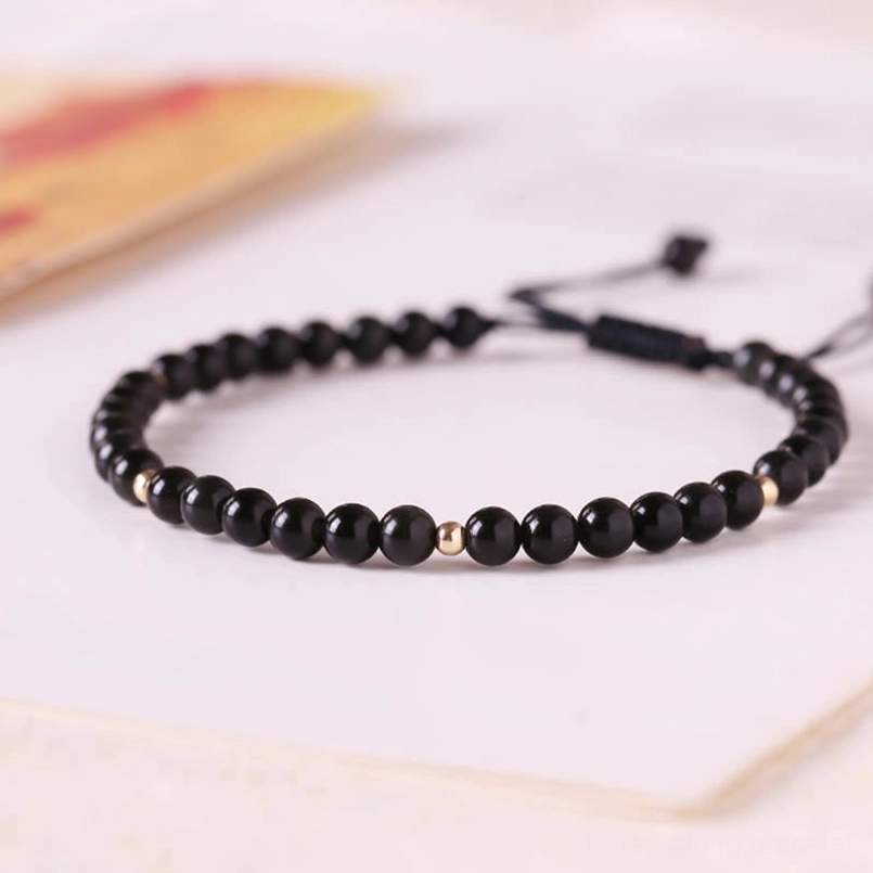 Black obsidian 4mm beaded red string protection bracelet detail shot with adjustable knot closure