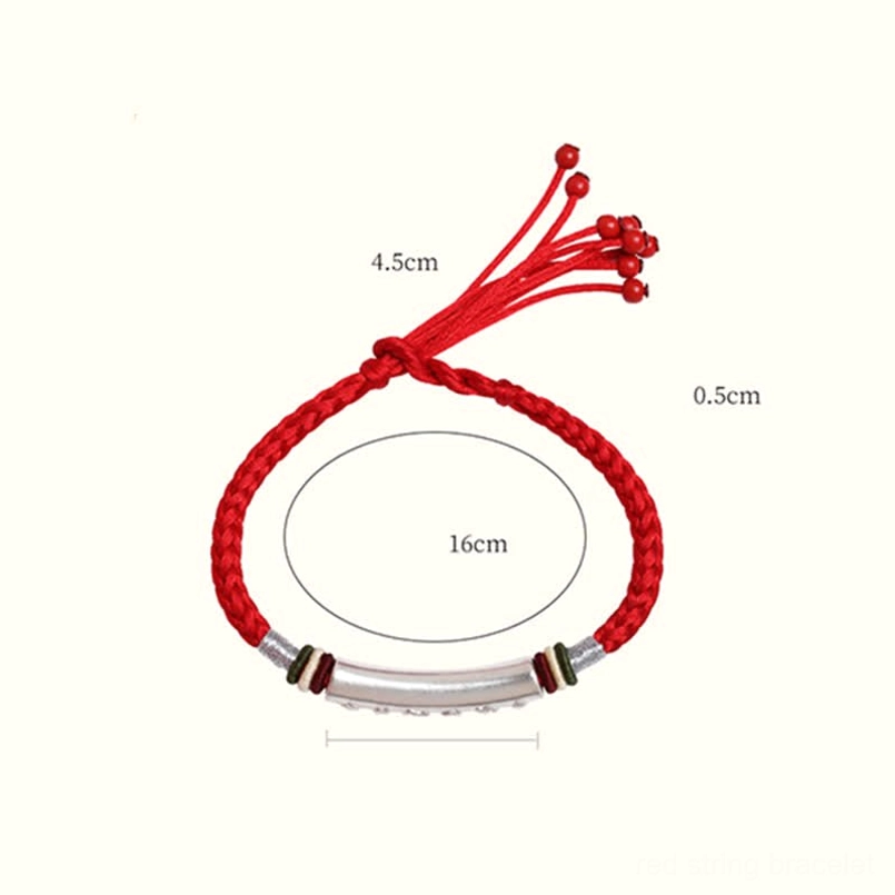 Close-up of Om Mani Padme Hum engraved silver tube and red braided cord bracelet