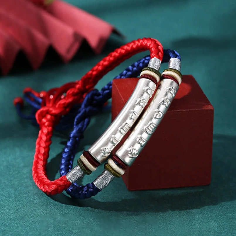 Pair of matching Om Mani Padme Hum bracelets in red and blue string with silver tube