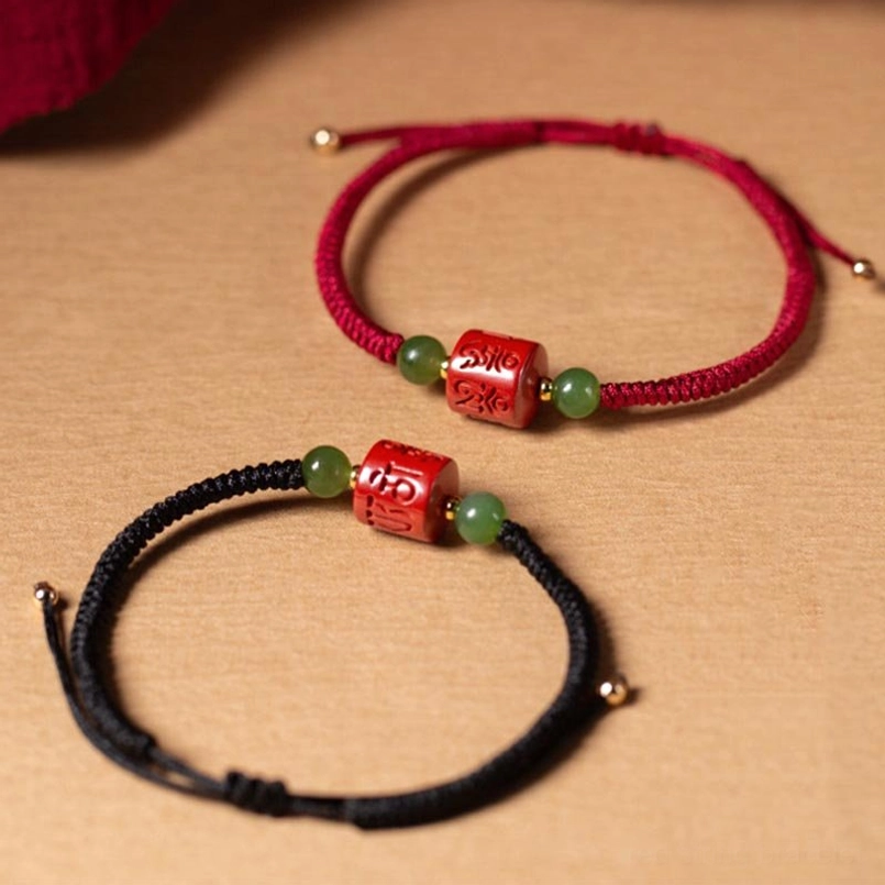 Red and black rope Tibetan mantra bracelets with cinnabar and jade beads, side-by-side comparison