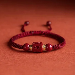 Om Mani Padme Hum cinnabar blessing bracelet with wine red braided cord front view