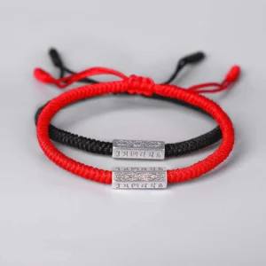 Couple Tibetan Om Mani Padme Hum red and black string bracelets with engraved silver mantra beads flat lay