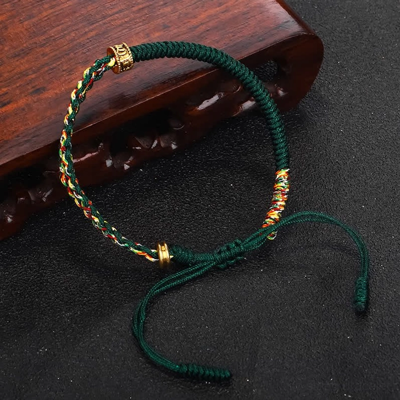 Om Mani Padme Hum green protection bracelet with woven accents and gold beads - angle shot