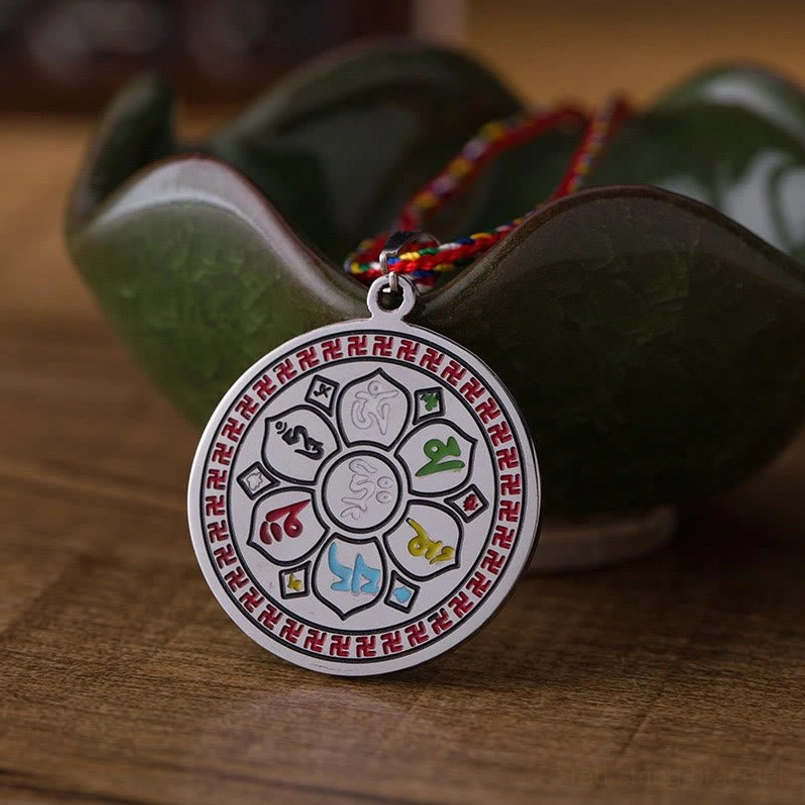 Six-syllable mantra round pendant with colored Buddhist symbols inlaid on silver disc