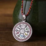 Om Mani Padme Hum titanium steel pendant with multicolor braided rope, silvery finish close-up