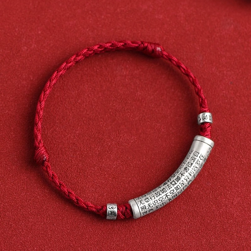 Red rope Heart Sutra bracelet top-down front view showcasing silver engraved pendant detail