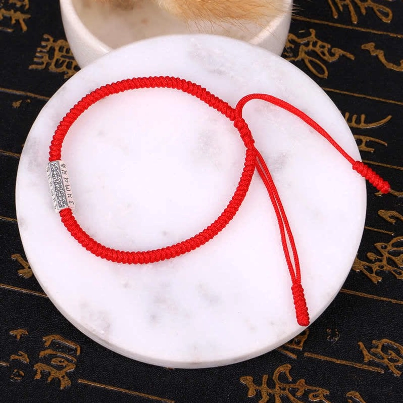 Single red Om Mani Padme Hum protection bracelet with braided cord and silver engraved charm