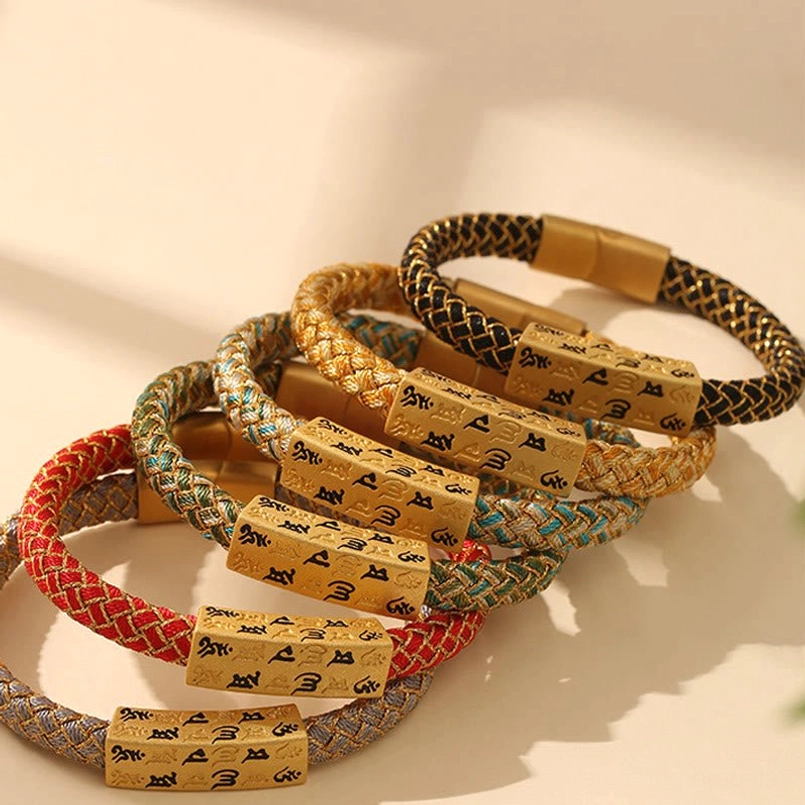 Flat lay arrangement of Om Mani Padme Hum Tibetan bracelet with size options displayed on white background