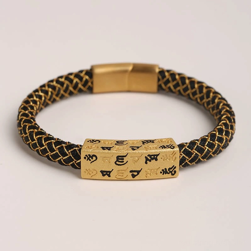 Flat lay view of black Om Mani Padme Hum Tibetan bracelet with gold accents and protective mantra charm