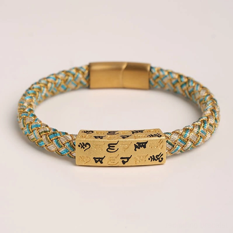 Flat lay view of blue Om Mani Padme Hum Tibetan bracelet with gold threading and rectangular mantra charm