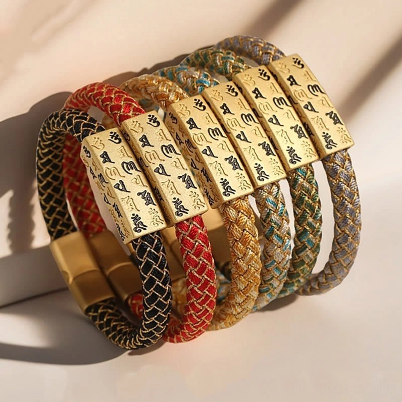 Front view of Om Mani Padme Hum Tibetan bracelet with gold rectangular charm and woven rope band