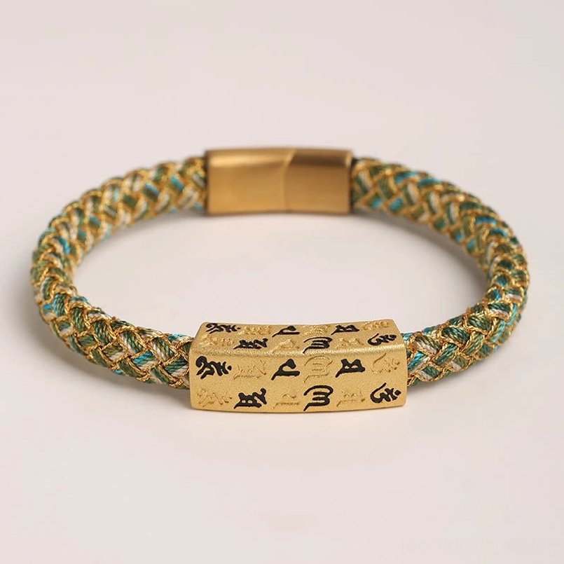 Flat lay view of green Om Mani Padme Hum Tibetan bracelet with gold threading and rectangular mantra charm