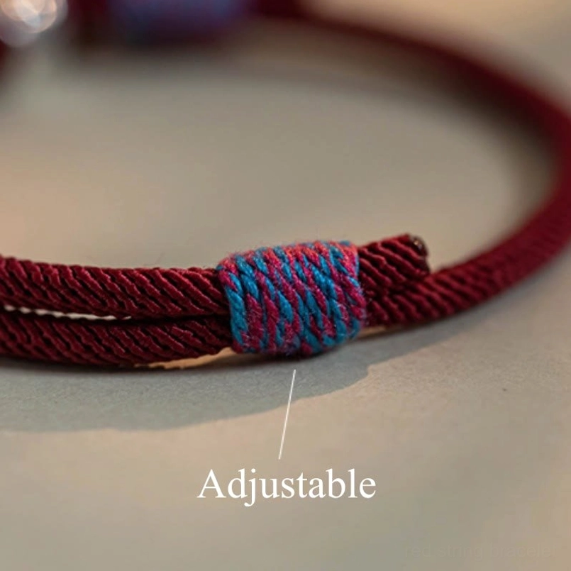 Handcrafted Tibetan bracelet featuring sacred mantra and persimmon silver bell
