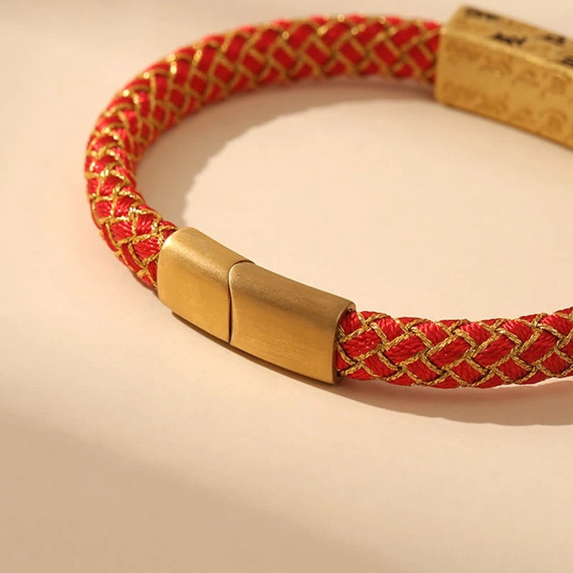 Side angle view of red Om Mani Padme Hum Tibetan bracelet showing woven rope texture and magnetic metal clasp