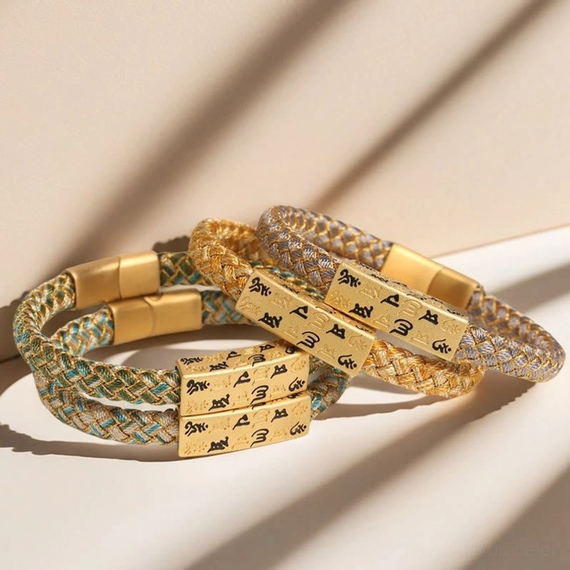 Om Mani Padme Hum Tibetan blessing bracelet detail showing woven rope construction and gold charm engraving