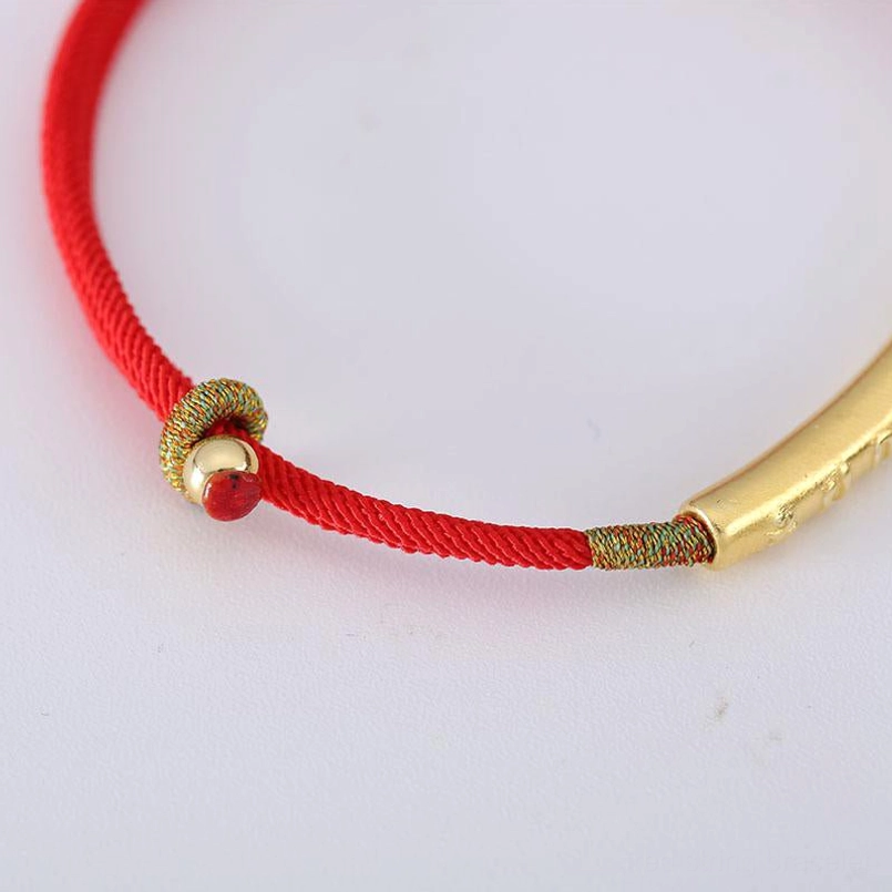 Tibetan Om Mani Padme Hum red string bracelet with gold tube bead, braided cord, and red accent bead detail