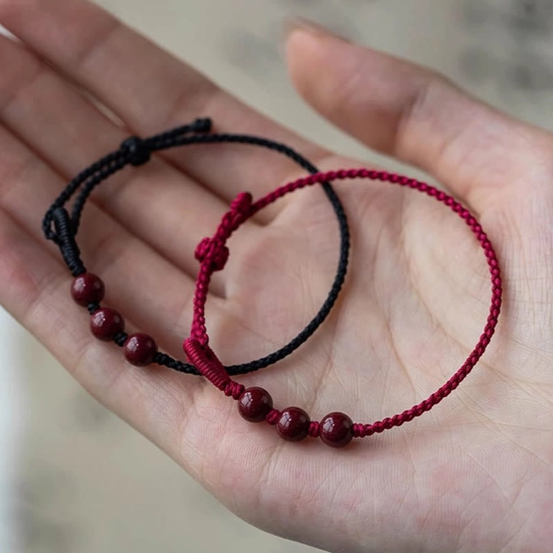 Pair of cinnabar bead bracelets unisex casual wear display